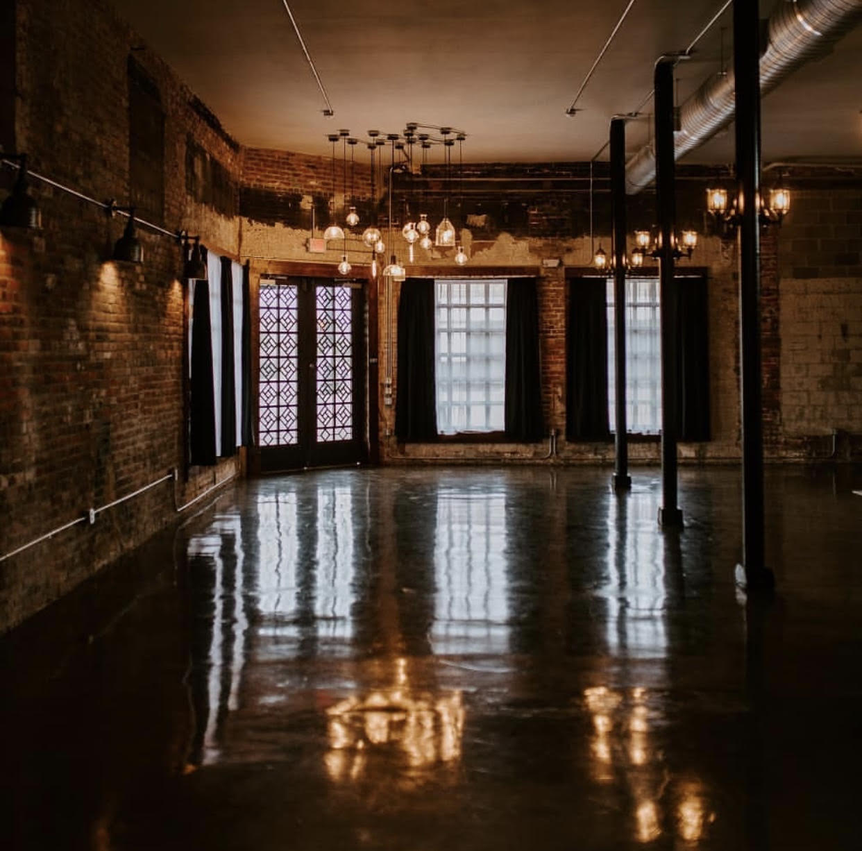 Large room with glossy concrete floors and lighting