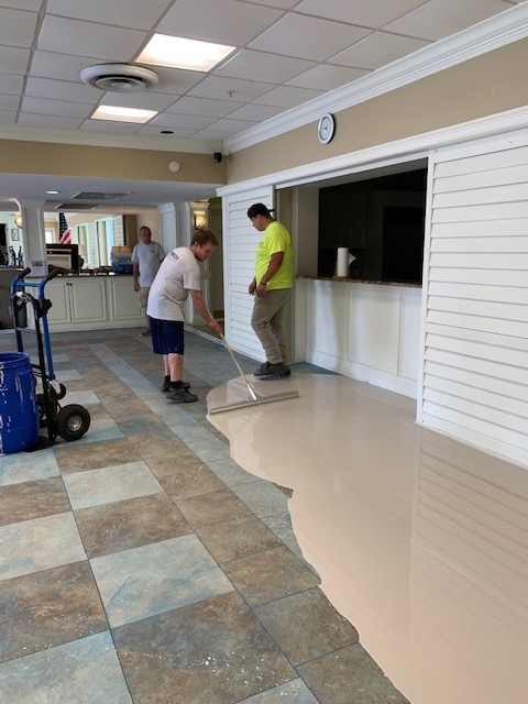 Man pouring floor leveler