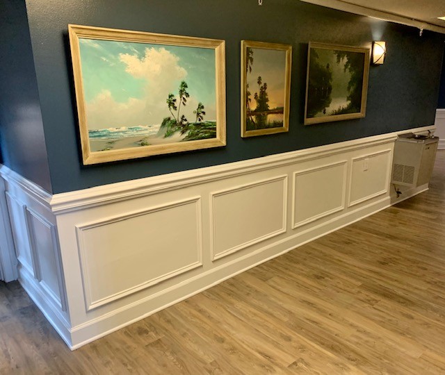 hallway with paintings on wall